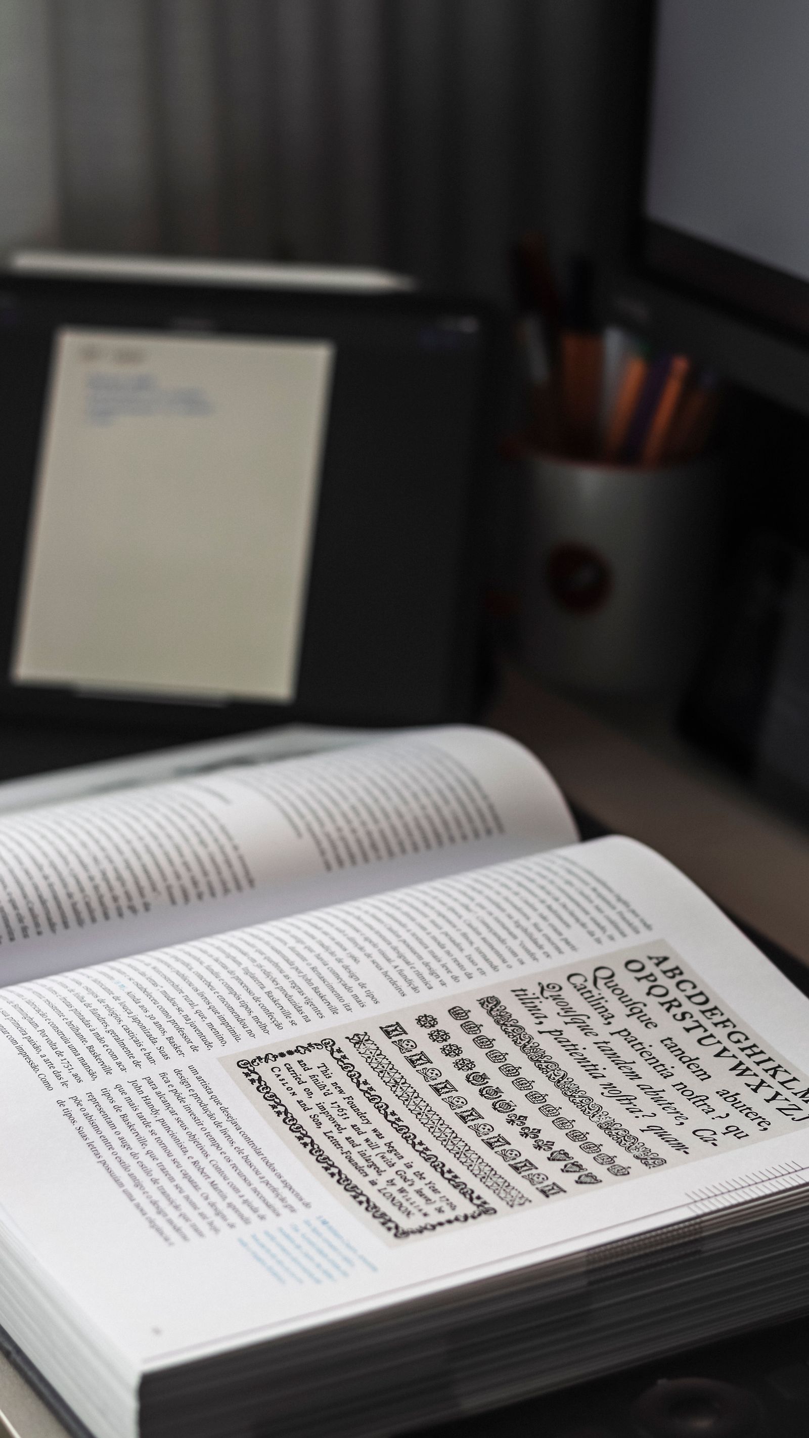 An open book showing typography on an editorial desk.