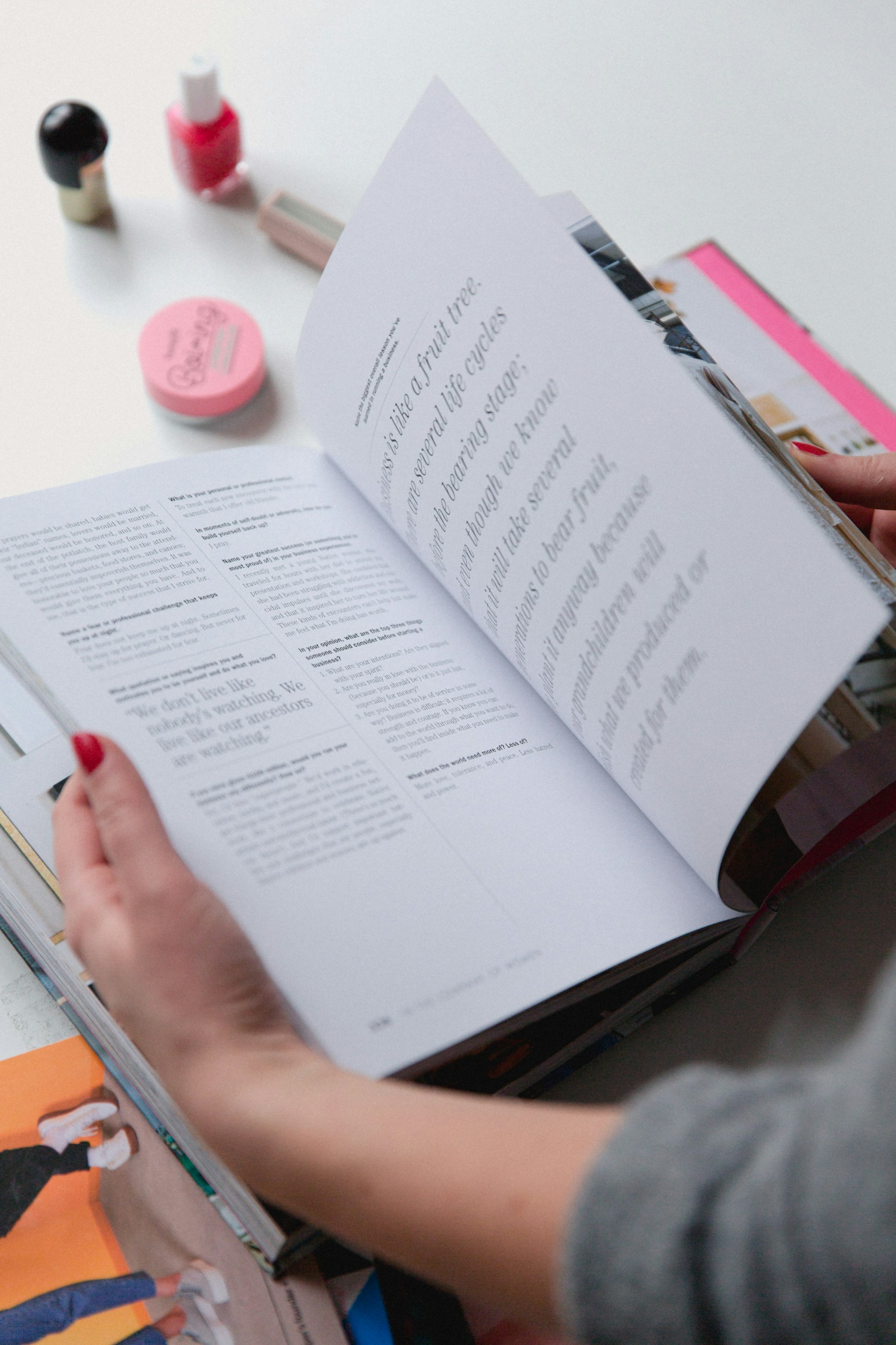 A reader turning through a printed book.