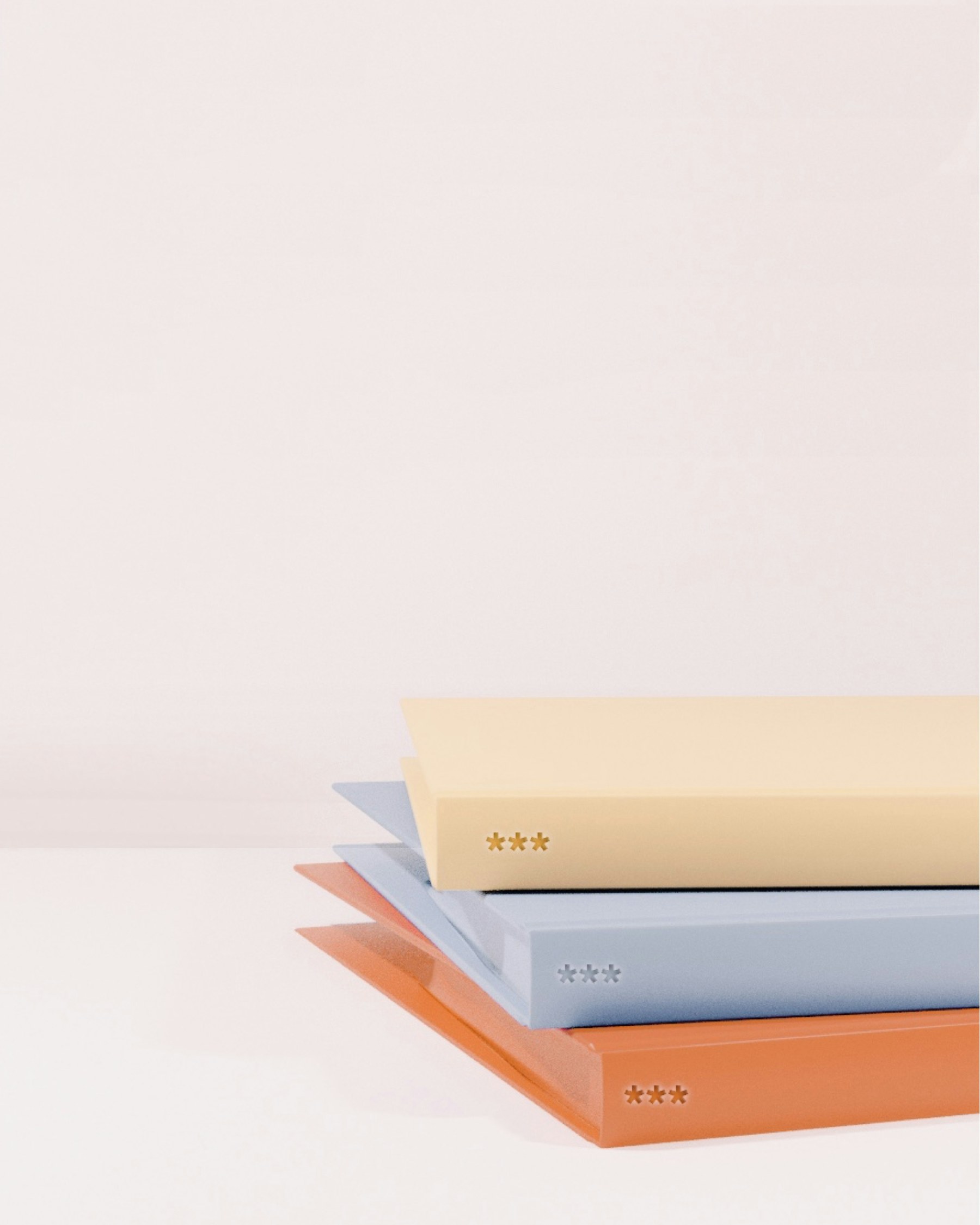 A minimal stack of books in muted neutral colors.
